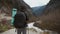 Lady hiker with backpack looking on hills and mountain river lake, girl enjoying nature panoramic landscape in trip