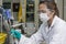 Lady holding and investigating chemicals in test glass