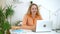 Lady home school online student. Talking on video call on laptop