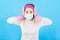 Lady house wife maid in face mask,latex gloves on hands, crazy bad mood dirty messy flat wear headband pink shirt isolated blue