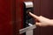 Lady inputing passwords on electronic door lock