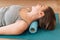 Lady kneading her neck with foam roller