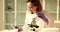 Lady laboratory scientist examining samples under microscope