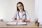 lady looking at the camera during a telemedicine consultation, consults a patient in a virtual meeting, telemedicine and