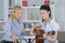 Lady music professor teaching guitar to young student