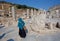 Lady in muslim scarf walking through ruined alley of Greek-Roman city Ephesus