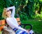 Lady needs relax and vacation. Girl sit bench relaxing in shadow, green nature background. Dream vacation. Woman blonde