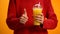 Lady with orange juice, hand showing thumbs up, healthy citrus cocktail, energy