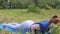 Lady in park practices yoga exercises, downward dog to upward cobra, strong body