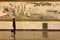 A lady passing by a Chinese painting in the Great Hall of People in Beijing