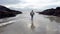 Lady performing a funny dance on the beach