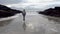 Lady performing a funny dance on the beach