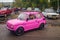 Lady in a pink little car