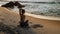 Lady practices yoga Cow Face exercise on ocean beach