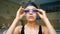 Lady puts on goggles ready to train in modern pool closeup