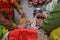 Lady putting turmeric on clay pot in indian weddings