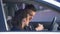 Lady quarreling with boyfriend drinking alcohol on driver seat, dangerous habit