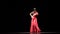 Lady in red. Flamenco Dance. Black background. Slow motion