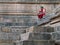 Lady rest on stone steps of Kunda, the reservoir of sun temple Modhera