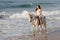 Lady riding horse beach