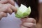 Lady`s hands folding Beautiful green organic Lotus`s leaf, instruction for flower folding, meditation