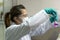 Lady scientist rinsing chemicals into test glass