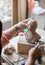 Lady sculptor working in her studio, ceramis artist`s hands