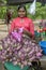 A lady selling pink lotus flowers at the Kataragama temple.