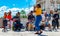 Lady singing in prace de comercio with her teammates entertaining all the tourist visiting tejo river bank