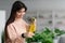 Lady spraying home plant with pure water from spray bottle