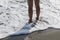 Lady standing on a sandy beach