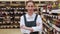 Lady store manager advertises alcohol department closeup