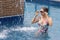 Lady at a swimming pool enjoying the fountain