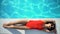 lady in swimwear enjoying sunbathing, lying at poolside, summer vacation