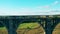 Lady tourist is enjoying the view on the old stone bridge