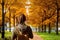 Lady traveller walk in Autumn park in Boston