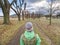 Lady in treking clothes walk in fall tree avenue