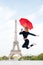 Lady with umbrella excited about visiting Eiffel Tower, sky background. Lady tourist sporty and active in Paris city