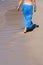 Lady walking on a sandy beach