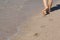 Lady walking on a sandy beach
