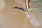 Lady walking on a sandy beach