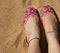 A lady wearing a pair of pink traditional Indian women`s shoes jutis at the Anjuna beach in Goa, India