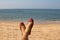 A lady wearing a pair of pink traditional Indian women`s shoes jutis at the Anjuna beach in Goa, India