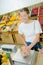 Lady weighing produce in paper bag