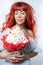 Lady woman with gorgeous red, fiery hair and a sweet bouquet in her hands Posing. White background in the studio