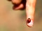 Ladybug with blacks dots on the index finger of a child