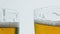 Lager beer glasses cheers gesture closeup. Full ale vessels toasting together