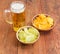Lager beer and two various potato chip in ceramic bowls