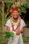 LAGO AGRIO, ECUADOR - NOVEMBER 17, 2016: Smiling Siona shaman in traditional dress with a feather hat in an indigenous