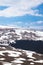 Lago Naki spring plateau with snowy hills, blue sky and clouds, Adygea, Russia